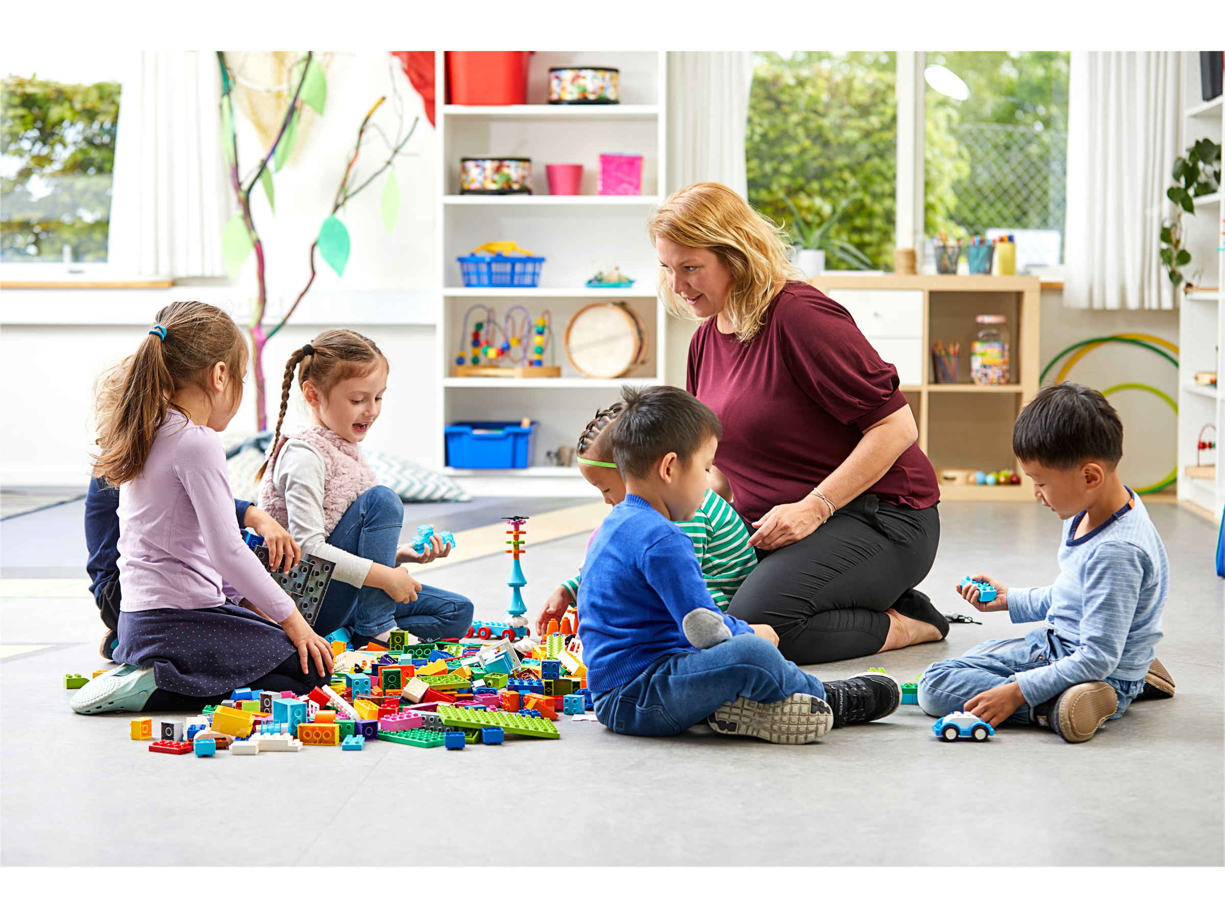 Six preschool children and a teacher playing with My XL World and developing their social skills.